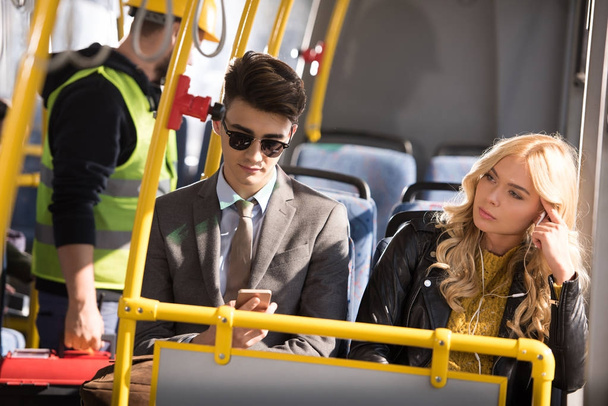 couple with smartphone in bus - Foto, afbeelding