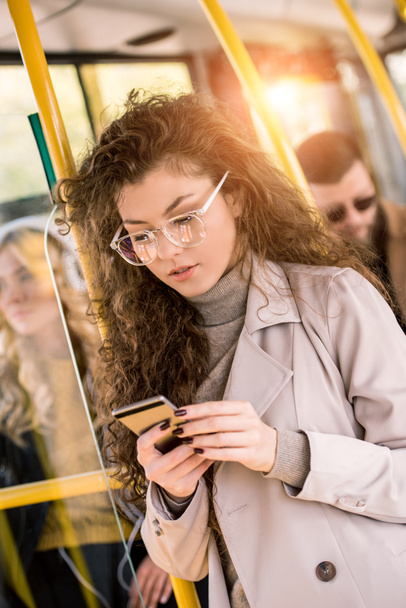 girl using smartphone in bus  - Фото, изображение