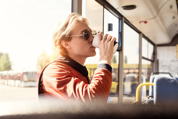 man drinking coffee in bus - Photo, Image