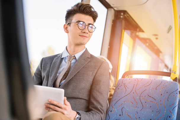 man with digital tablet in bus - Foto, afbeelding
