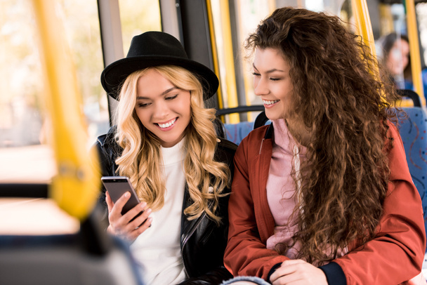 girls using smartphone in bus - Zdjęcie, obraz