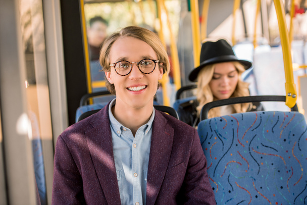 young man in eyeglasses in bus - 写真・画像
