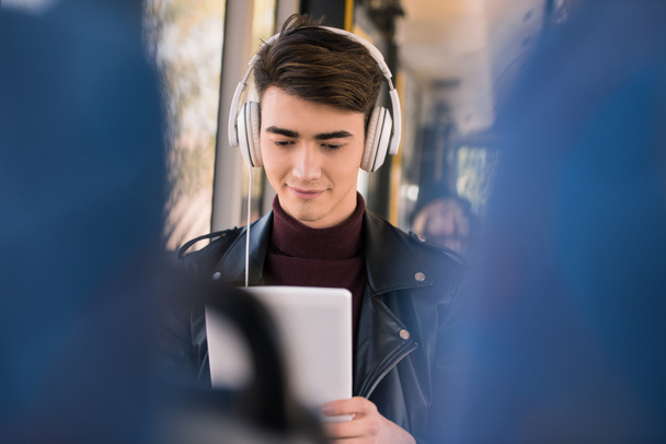 man in headphones with digital tablet - Photo, Image