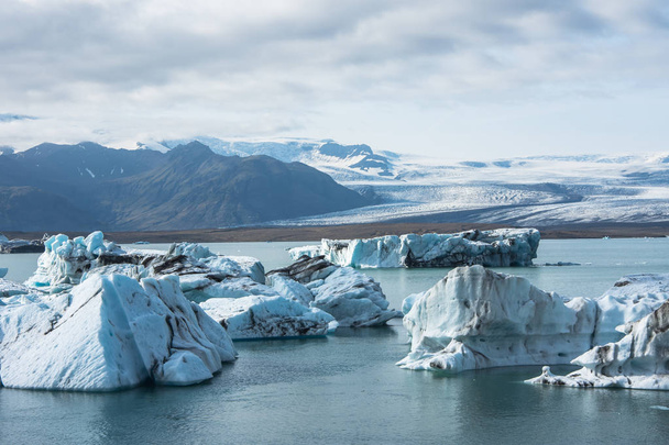 gedetailleerde foto van de ijsberg van IJslands grootste gletsjer in een ijs lagune met ongelooflijk levendige kleuren en een mooie textuur - Foto, afbeelding