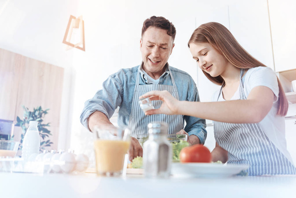 Positive dad and daughter during meal preparation - Foto, Bild