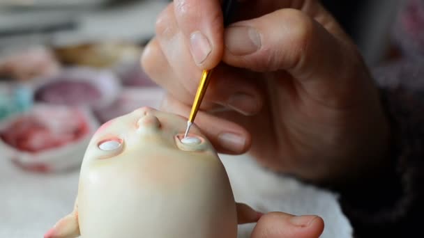 Master puppeteer draws eyes for dolls.  - Footage, Video