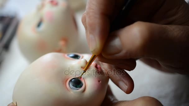 Master puppeteer draws eyes for dolls. - Footage, Video
