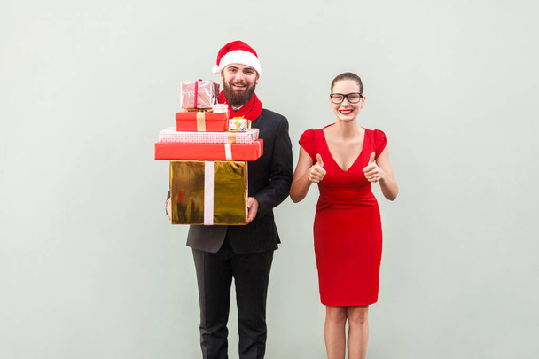 Christmas, gifts concept. Bearded businessman holding many gift  - 写真・画像