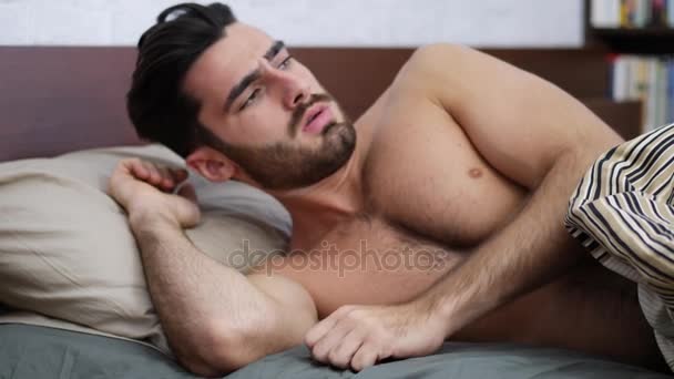 Young Sleepy Man, Lying in Bed Waking Up - Video, Çekim