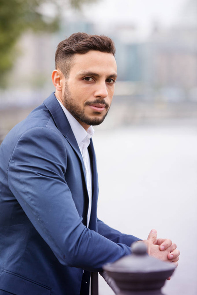 handsome businessman standing by the river - Foto, immagini