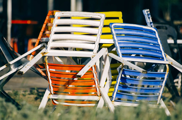 барвисті стільці під яскравим сонячним днем біля берега
 - Фото, зображення