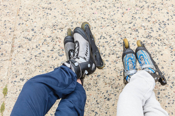 Closeup of people friends with roller skates. - 写真・画像