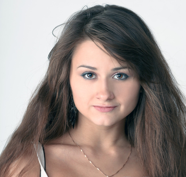 Emotional portrait of cute young girl with beautiful brown hair - Foto, afbeelding