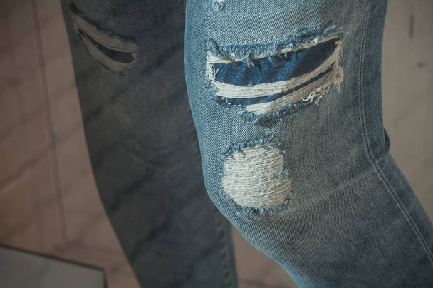  torned blue jeans in women store showroom - Photo, image