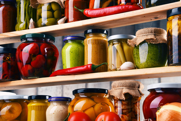 Jars with variety of pickled vegetables. - Photo, Image