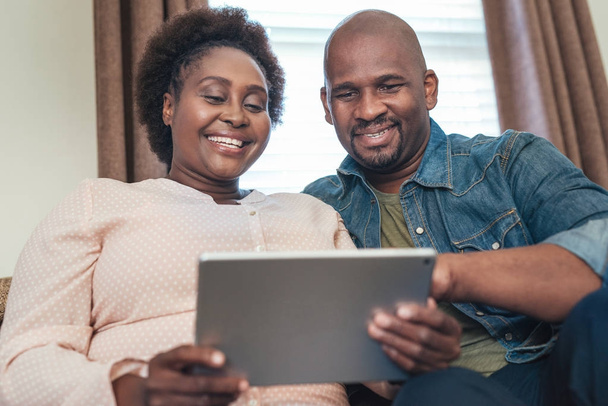 couple using digital tablet on sofa - Photo, image
