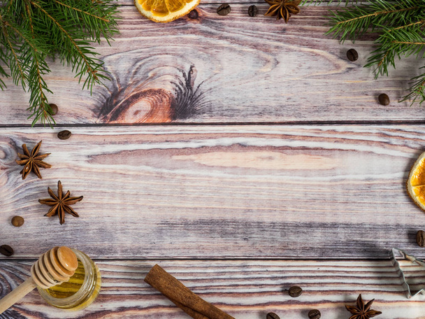 Christmas decorations on wooden background, orange, cinnamon, stars, fir branches. Copy space. - Foto, imagen