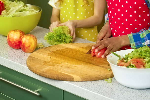 Hands of kid cutting tomato. - Foto, imagen