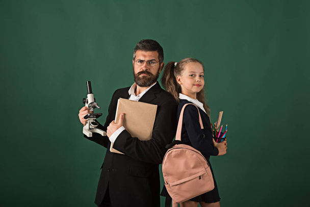 Man and girl with bag wearing school uniform - Zdjęcie, obraz