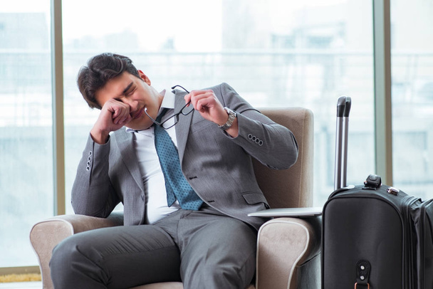 Young businessman in airport business lounge waiting for flight - 写真・画像