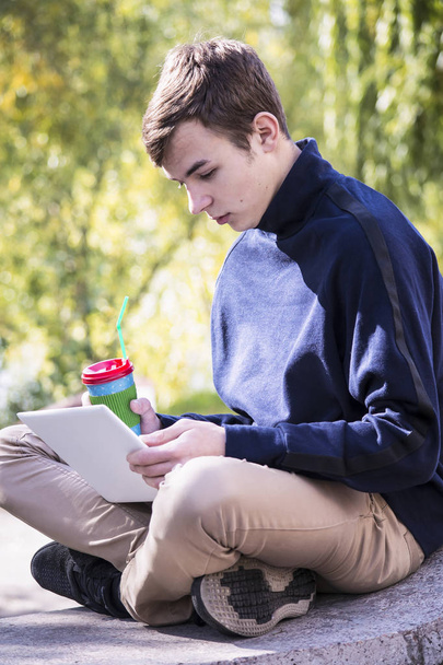  teenager works behind a laptop  - Φωτογραφία, εικόνα