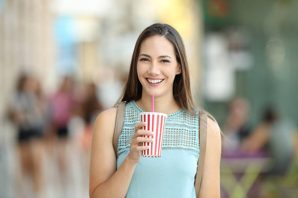Front portrait of a girl holding a take away drink - Φωτογραφία, εικόνα