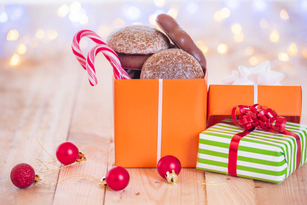 Gift with sweets in Christmas atmosphere - Photo, Image
