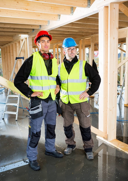 Carpenters In Protective Clothing At Construction Site - Photo, Image