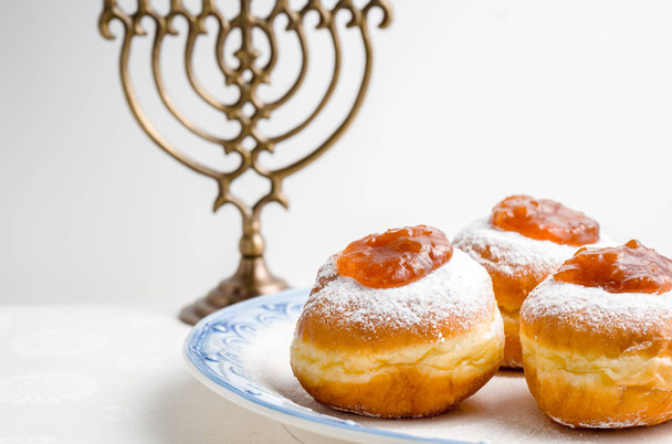Hanukkah Minor, donuts with jam on a plate on a white background - Фото, изображение