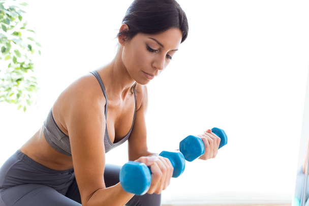 girl exercising with two dumbbells - Photo, Image