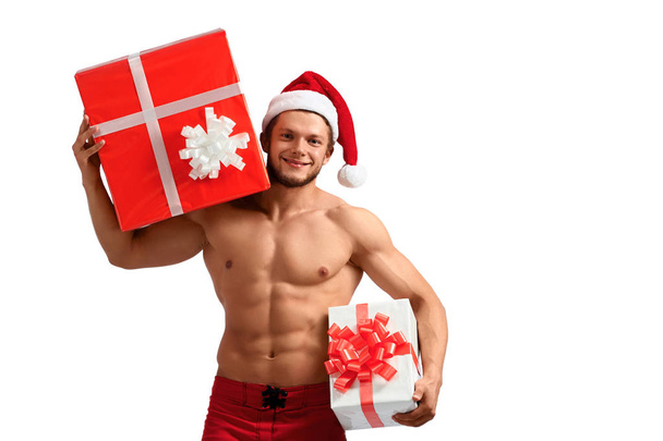 Muscular Santa Claus holding presents - 写真・画像