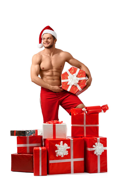 Sexy Santa Claus man with a pile of presents - Photo, image