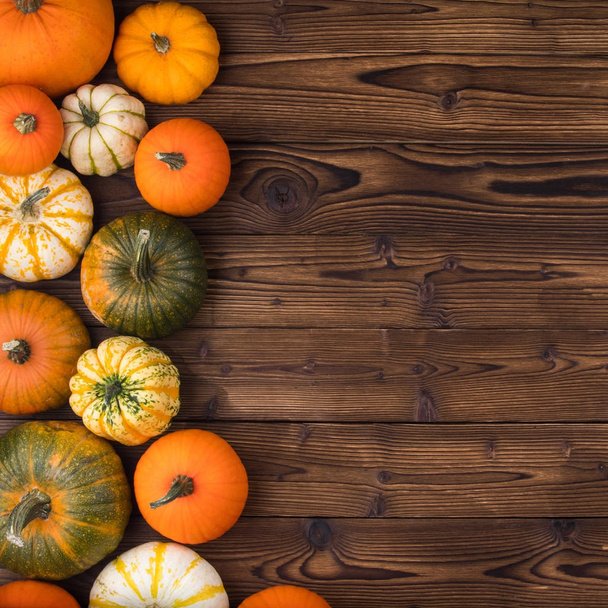Pumpkins on wooden background - 写真・画像