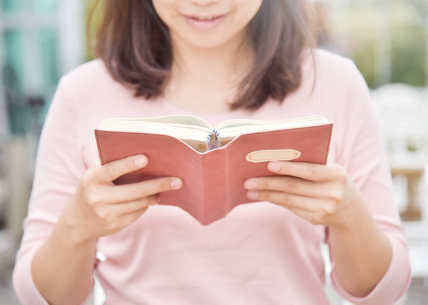 Happy Beautiful Asian Woman reading a book. - Фото, зображення