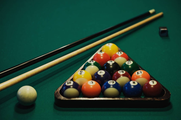 Playing billiard. Billiards balls and cue on green billiards table. Billiard sport concept. - Photo, Image