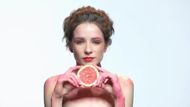Frau hält Grapefruitscheibe in der Hand. - Filmmaterial, Video