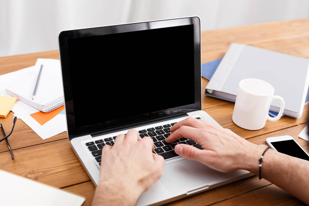 Hands typing on a laptop in modern office, closeup - Zdjęcie, obraz