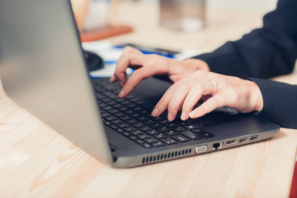 womens hands are typing on laptops keyboard. - Фото, зображення