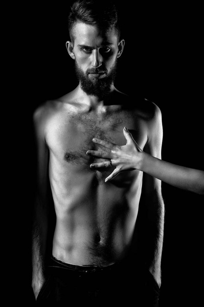 slim bearded man with thin bare torso isolated on black - Foto, Imagen