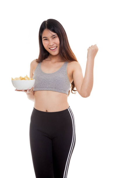 Beautiful Asian healthy girl  eat potato chips. - Fotó, kép