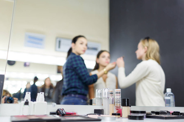 A make-up artist is applying makeup to a young girl. - Fotoğraf, Görsel
