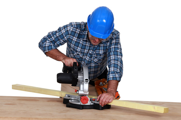 Woodworker using miter saw - Foto, imagen