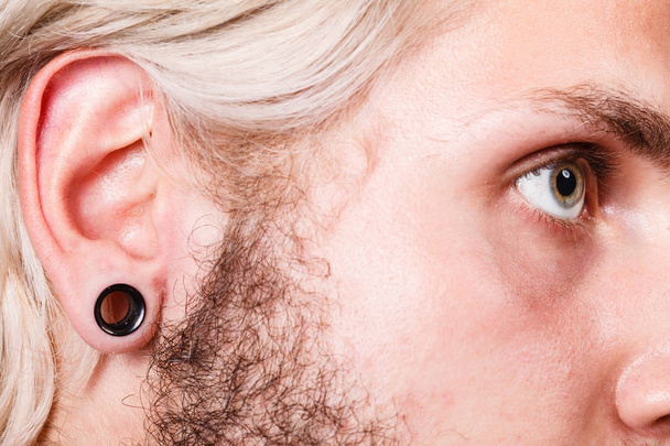 Pierced man ear, black plug tunnel - Photo, Image