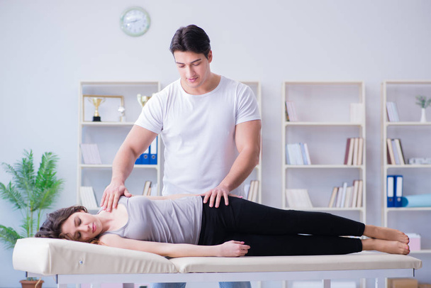Young doctor chiropractor massaging female patient woman - Photo, Image