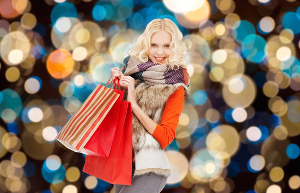 young woman in winter clothes with shopping bags - Фото, изображение