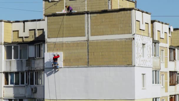 Arbeiter dämmt Mauer-Hochhaus - Filmmaterial, Video