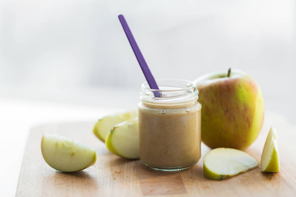 jar with apple fruit puree or baby food on table - Valokuva, kuva