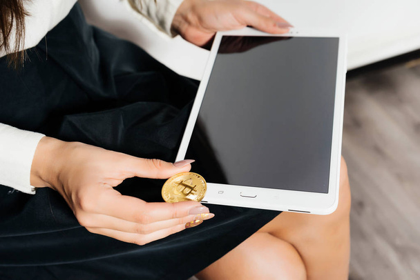 business lady holding a tablet and gold bitcoin,  virtual cryptocurrency concept  - 写真・画像