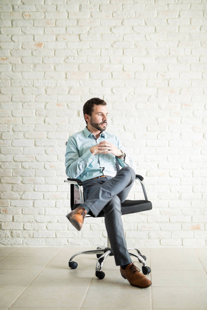 Business owner sitting on a chair - Фото, зображення