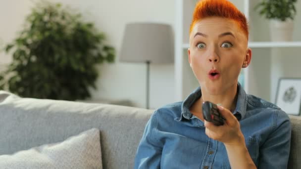 woman using tv remote control - Video